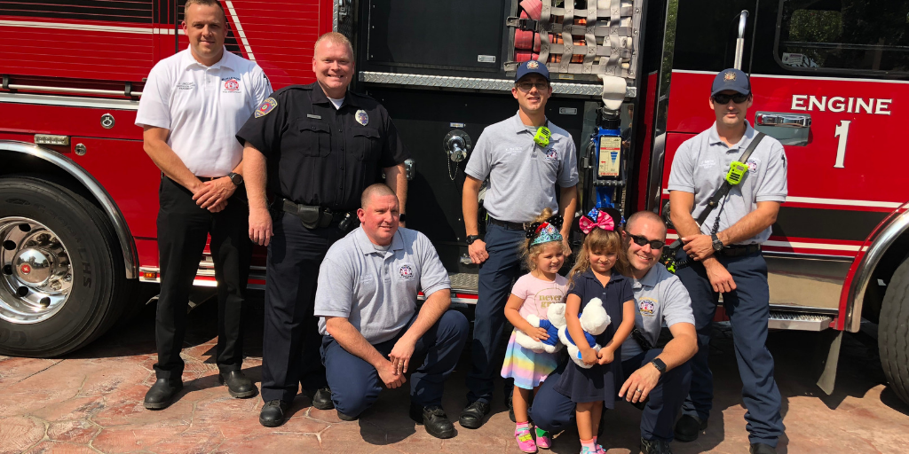Burleson firefighter and little girl in front of firetruck 