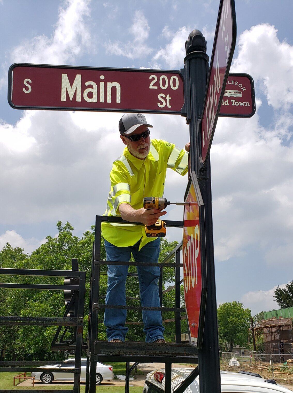 Photo of Traffic worker fixing stop sign