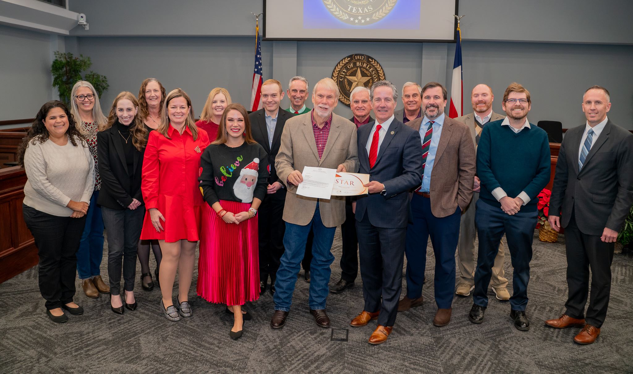 a photo of Acting Comptroller Kelly Hancock presents finance department with transparency star