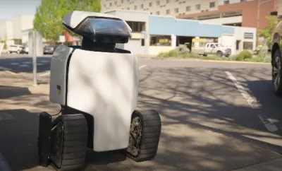 a photo of a daxbot robot on a sidewalk